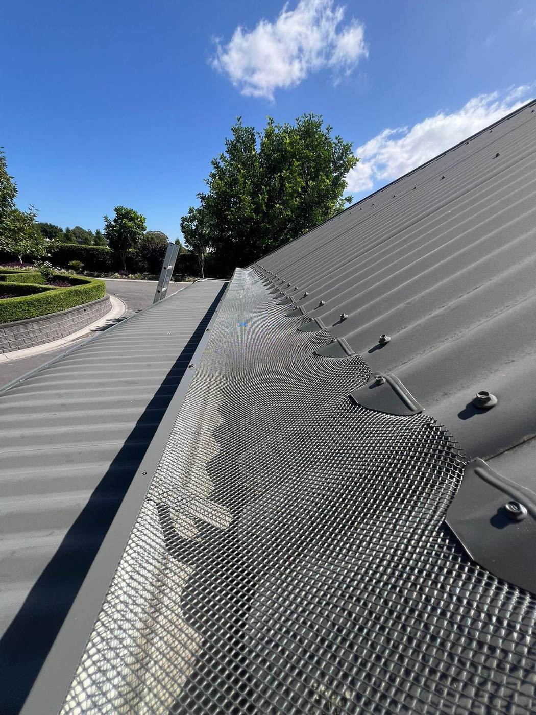 Aluminium gutter guard mesh on a metal roof