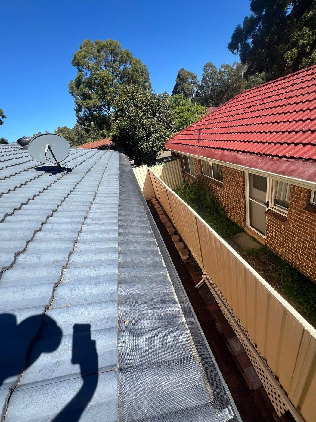 Gutter guard mesh fitted on a tiled roof
