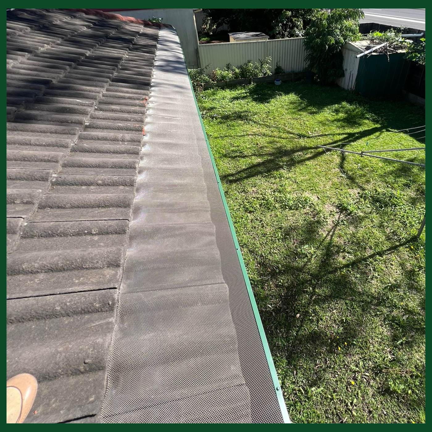 Tile roof with gutter guard mesh fitted along the gutter line, Holsworthy