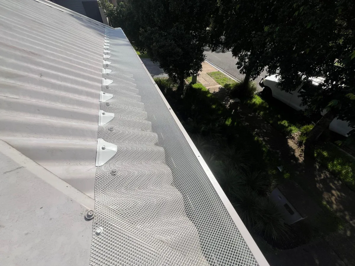 Finished gutter guard mesh installation on a metal roof